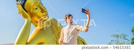 Happy man tourist on background ofLying Buddha statue BANNER, LONG FORMAT Happy man tourist on background ofLying Buddha statue BANNER, LONG FORMAT 54615381