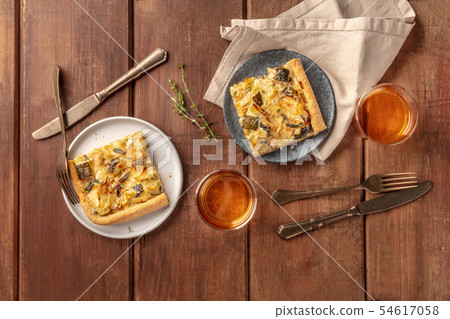 Slices of a zucchini and goat cheese pie with thyme and white wine, shot from the top on a dark 54617058