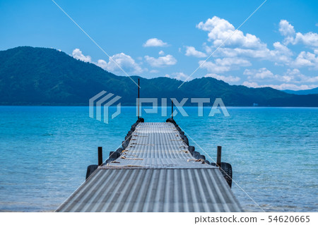 A long pier leading to the surface of the water A long pier leading to the surface of the water 54620665