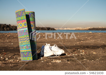 White crosses and yoga mat on the seashore against 54621830