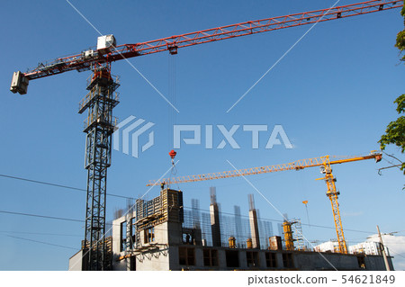 Two Construction cranes tower on blue sky 54621849