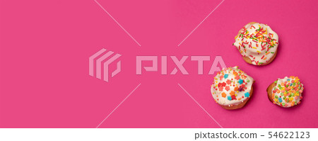 Creative flat lay food concept of sweet cake with multi-colored decoration on a pink background Creative flat lay food concept of sweet cake with multi-colored decoration on a pink background 54622123