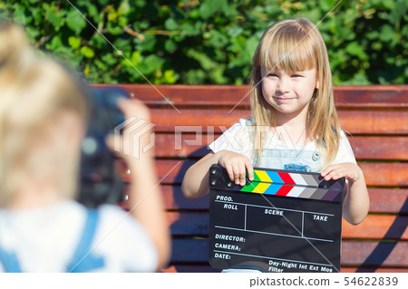 Little girls record a video blog on the camera 54622839