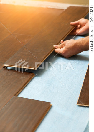 Man Installing New Laminate Wood Flooring 54623213
