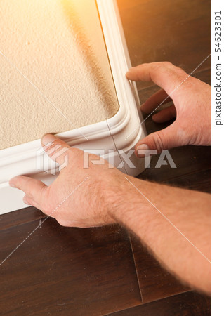 Contractor Installing New Baseboard with Bull Nose 54623301