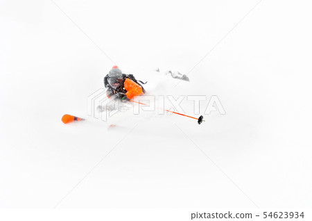 Professional Skier athlete rides out of deep snow while performing a skiing trick in a snowstorm Professional Skier athlete rides out of deep snow while performing a skiing trick in a snowstorm 54623934