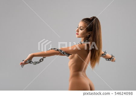 Nude brunette wrapped in chain croped rearview 54624098