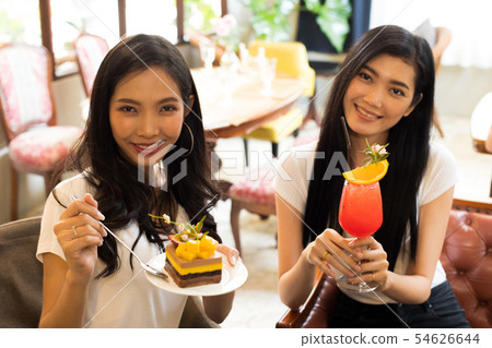 Best friends smile together for beautiful cake 54626644