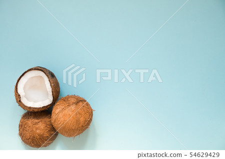 Flat lay with ripe coconuts on blue background Flat lay with ripe coconuts on blue background 54629429