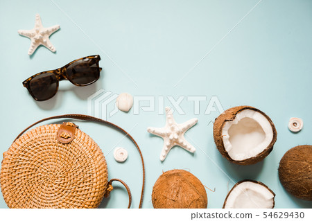 Flat lay with ripe coconuts on blue background 54629430