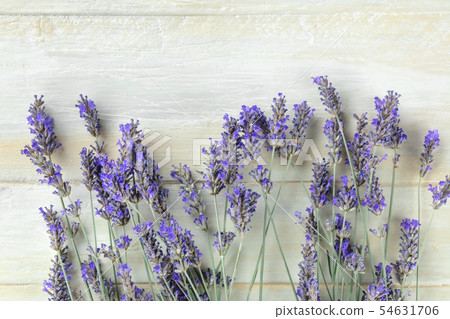 A fresh bouquet of blooming lavender flowers, shot from above on a rustic wooden background with 54631706
