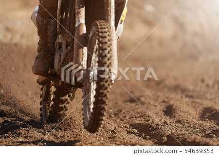 Motocross racer accelerating speed in track Motocross racer accelerating speed in track 54639353