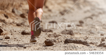 Trail running action close up of running shoes Trail running action close up of running shoes 54639354