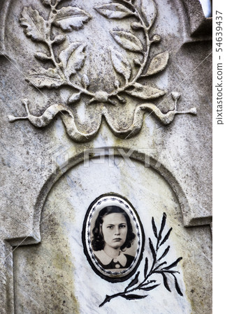 Portrait of the young woman on the old gravestone 54639437
