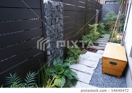 A small garden with a gabion Light up when twilight A small garden with a gabion Light up when twilight 54640472