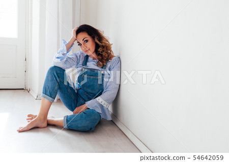 Portrait of a beautiful woman in a denim jumpsuit Portrait of a beautiful woman in a denim jumpsuit 54642059