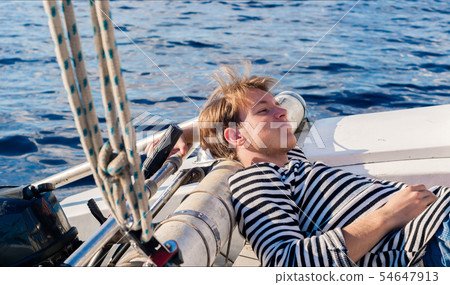 young sailor resting while calm 54647913