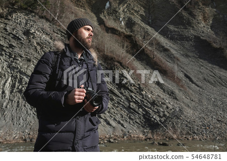 Portrait of a bearded traveller with camera 54648781