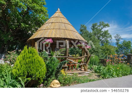 Wooden Gazebo in backyard or in summer garden. Wooden Gazebo in backyard or in summer garden. 54650276