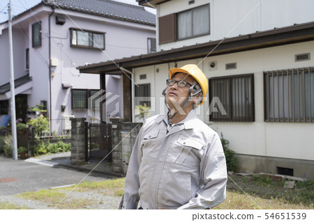 Field worker looking up at a building Field worker looking up at a building 54651539
