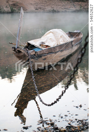Empty old wooden boat on the waves close up Empty old wooden boat on the waves close up 54652627