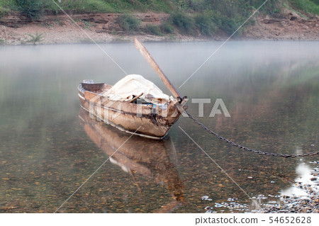 Empty old wooden boat on the waves close up Empty old wooden boat on the waves close up 54652628