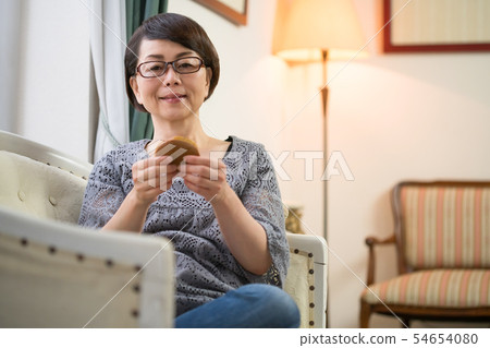 Woman eating confectionery 54654080