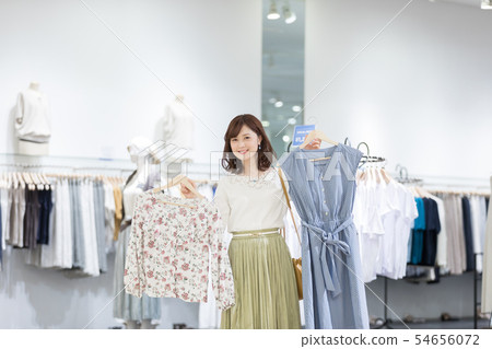 Shopping mall apparel shopping female person choosing 54656072