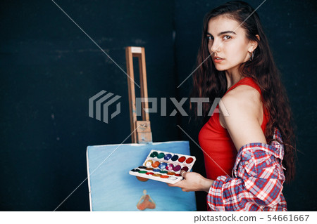Elegant girl draws in an art studio Elegant girl draws in an art studio 54661667