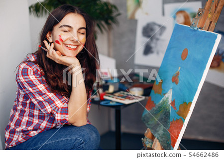 Elegant girl draws in an art studio Elegant girl draws in an art studio 54662486