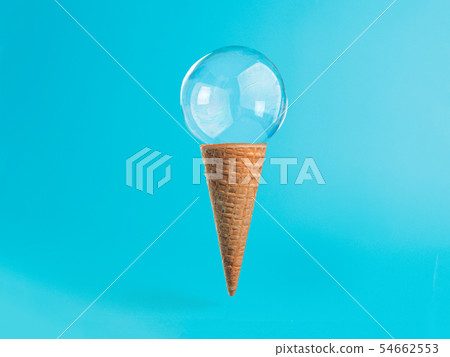 Ice cream cone with soap bubble on blue background Ice cream cone with soap bubble on blue background 54662553