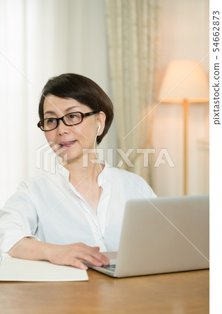 Middle woman doing home work 54662873