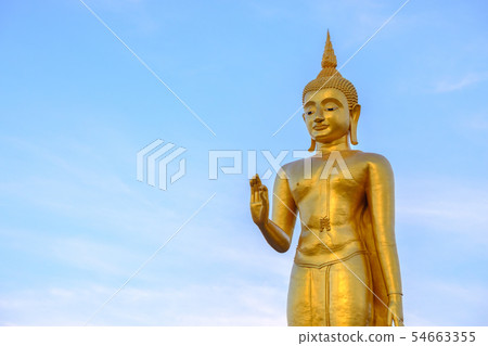 Golden buddha on blue sky backgrond with copy spac 54663355