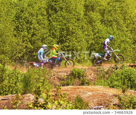 Motocross riders practice tricks on their dirt Motocross riders practice tricks on their dirt 54663926
