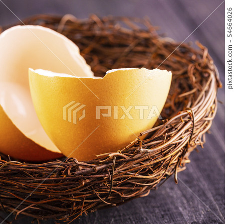 The broken egg shells in the nest on the old 54664026