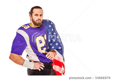 Patriotic american football player posing at camera on white background with usa flag. The concept 54666979