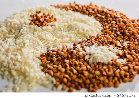 The symbol of yin yang is laid out of buckwheat The symbol of yin yang is laid out of buckwheat 54672172