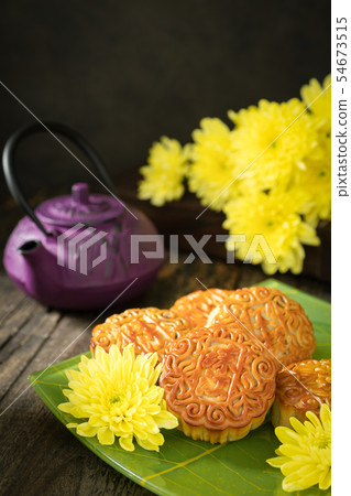 Mooncakes, teapot, yellow chrysanthemum flowers. Mooncakes, teapot, yellow chrysanthemum flowers. 54673515