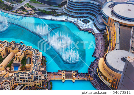 Dubai mall fountain and downtown buildings 54673811