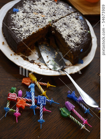 half-eaten birthday cake and extinguished candles half-eaten birthday cake and extinguished candles 54673989