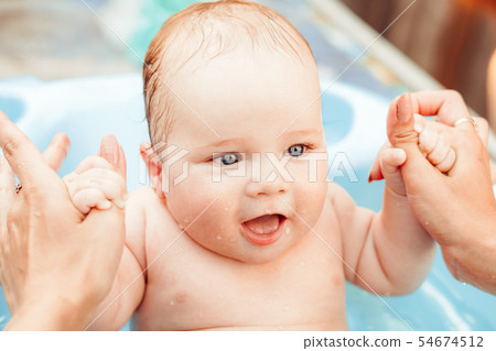 baby boy bathed in the outdoor tub baby boy bathed in the outdoor tub 54674512
