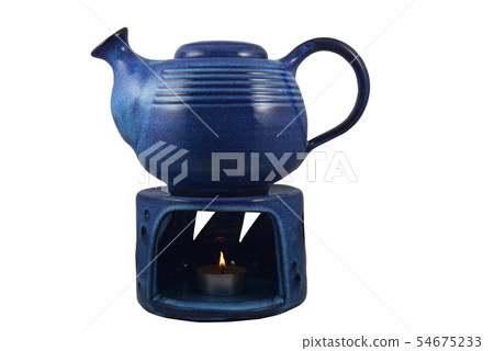blue ceramic teapot with a candle heated on a blue ceramic teapot with a candle heated on a 54675233