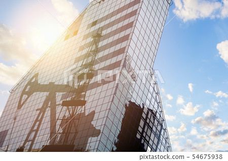 Modern office building with oil derrick 54675938