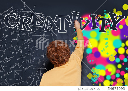 Kid writing Creativity on blackboard background Kid writing Creativity on blackboard background 54675993