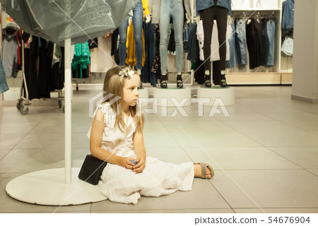 Kid girl wait mommy in shop. Children fatigue Kid girl wait mommy in shop. Children fatigue 54676904