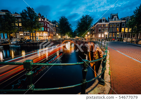 Evening in Amsterdam city, light trails and reflections on water at the Leidsegracht and Evening in Amsterdam city, light trails and reflections on water at the Leidsegracht and 54677079