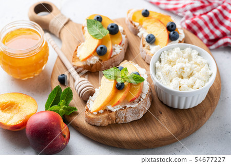 Fruit and ricotta cheese bruschetta Fruit and ricotta cheese bruschetta 54677227