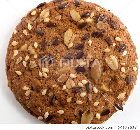 Macro photo of brown dietary low-calorie fitness cereal biscuits with sprinkling closeup on white 54678638