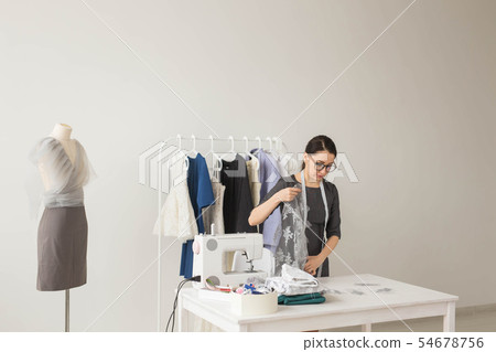 Dressmaker, fashion designer and tailor concept - Fashion designer woman working in the studio 54678756