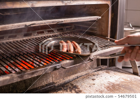 food, delicious and meat dishes concept - Horse sausages prepared on barbeque food, delicious and meat dishes concept - Horse sausages prepared on barbeque 54679501